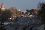 After departing Western Springs, an outbound Metra approaches as the Southwest Chief comes up behind it